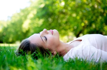 Beautiful woman relaxing outdoors lying on the floor